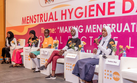 Adolescent girls hold a panel discussion as part of the MHD Symposium